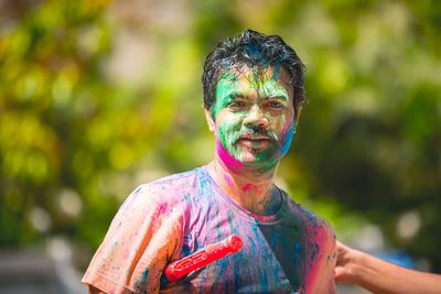 Portrait of man with face paint during holi