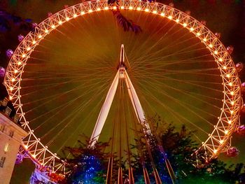 Illuminated ferris wheel at night