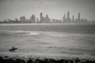 Scenic view of sea with city in background