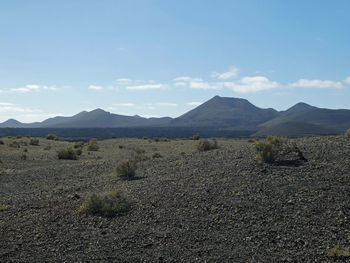 Scenic view of volcanic field against sky