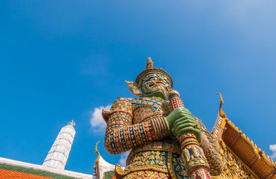 Low angle view of statue against blue sky