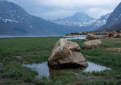 Scenic view of lake and mountains against sky