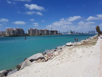 Panoramic view of sea and buildings against sky