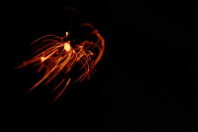 Close-up of illuminated light over black background