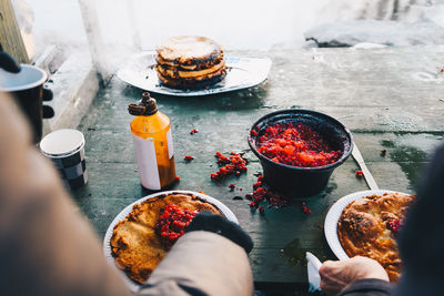 Cropped image of people preparing food on table