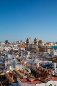 Cityscape against clear blue sky