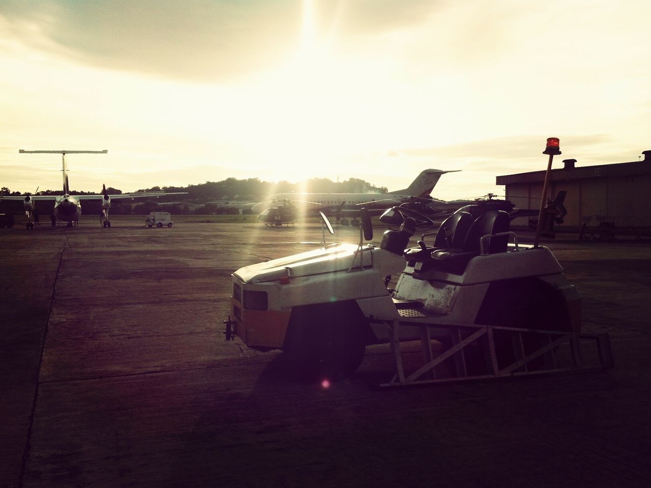 sunset, sun, sky, transportation, sunlight, mode of transport, sunbeam, orange color, lens flare, cloud - sky, land vehicle, car, built structure, architecture, silhouette, outdoors, building exterior, no people, nature, bright