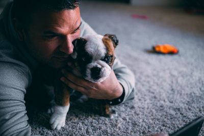 Close-up of man taking selfie with puppy