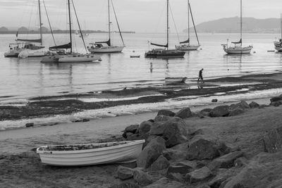 Boats moored on sea against sky