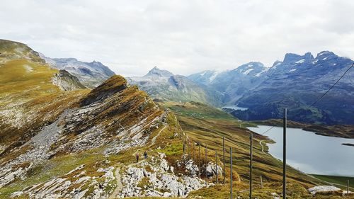 Fencing on snowcapped mountains against sky