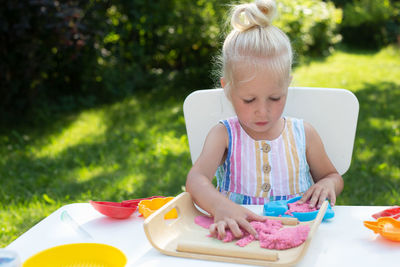 Close-up of girl with ice cream on table