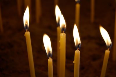 Close-up of candles burning in temple