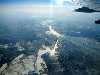 Aerial view of airplane wing over landscape