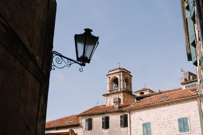 Low angle view of street light against building