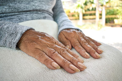 Close-up of woman hand on carpet