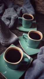 High angle view of coffee in cups on table