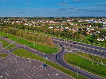 High angle view of road amidst field against sky