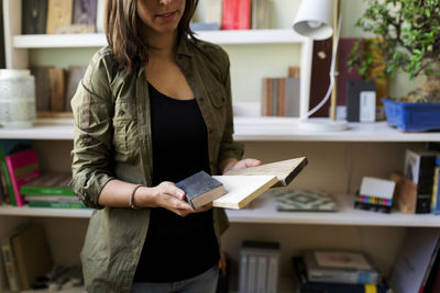 Young woman reading book at home