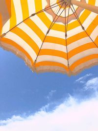 Low angle view of umbrella against blue sky