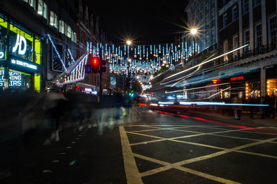 Illuminated city street at night