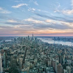 Aerial view of city buildings against cloudy sky nyc 