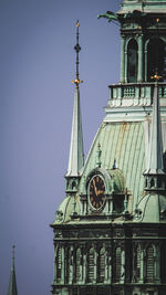 Low angle view of clock tower against sky
