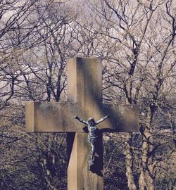 Crucifix against bare trees