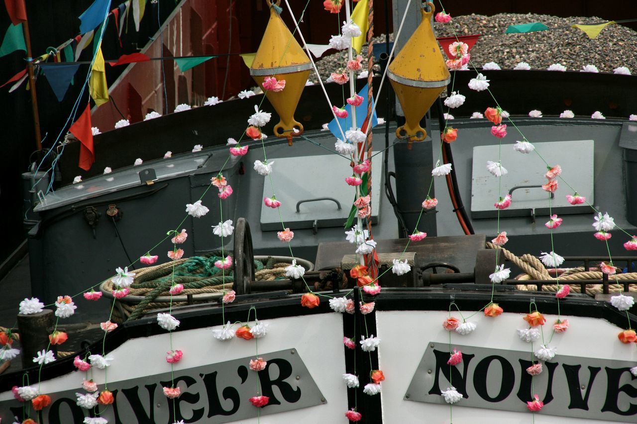 transportation, multi colored, variation, large group of objects, abundance, mode of transport, hanging, in a row, outdoors, high angle view, text, no people, street, day, close-up, metal, land vehicle, western script, car, choice