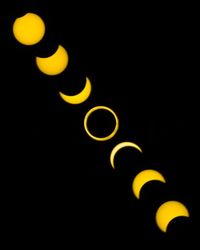 Low angle view of illuminated yellow lights against sky at night