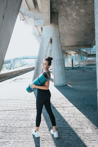 Full length of woman standing on bridge