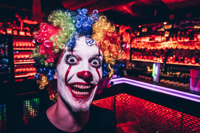 Portrait of smiling young man in clown costume