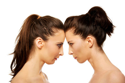 Portrait of a young woman against white background