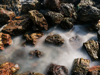 High angle view of stream by rocks