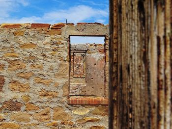 Old rusty metal structure against sky