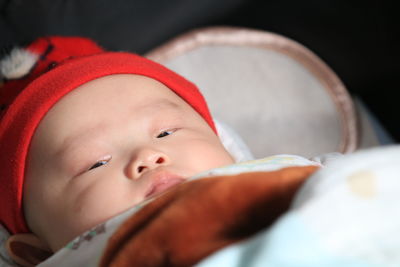 Close-up of cute baby boy sleeping on bed at home