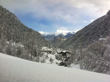 Scenic view of mountains against cloudy sky