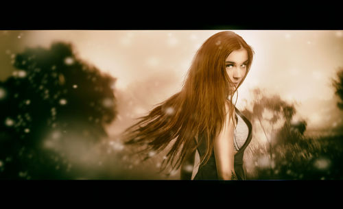 Portrait of woman standing against sky