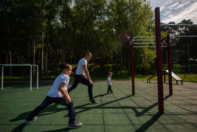 Rear view of children playing on playground