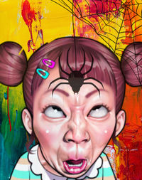 Close-up portrait of woman against graffiti wall