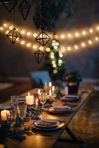 Candles on table in illuminated room during christmas