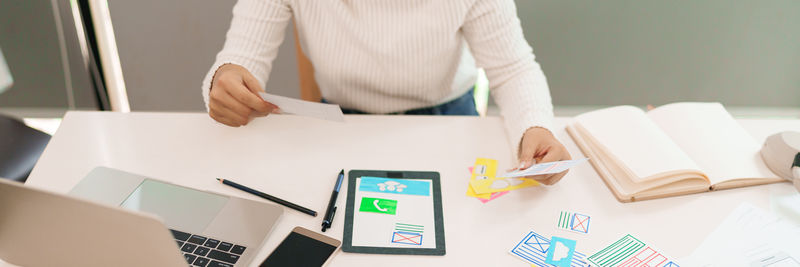 Midsection of businessman using digital tablet in office