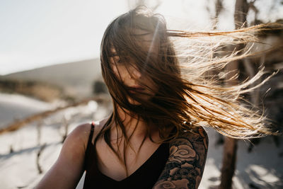 Young woman with long hair at beach