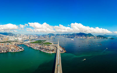 High angle view of sailboats in sea against blue sky