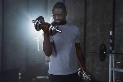 Rear view of man exercising in gym