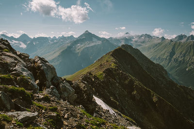 Scenic view of mountains against cloudy sky