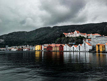 Scenic view of sea by buildings against sky