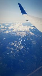 Cropped image of airplane flying over landscape
