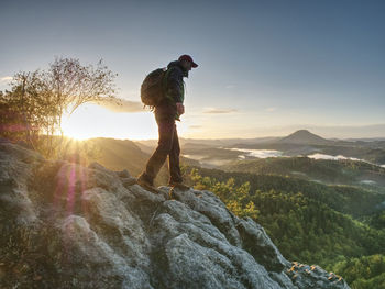 Man standing on mountain against sky