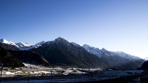 Scenic view of mountains against blue sky