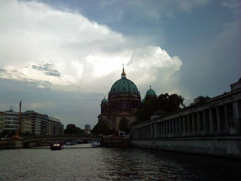 Buildings against cloudy sky